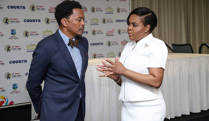 Minister of Sport and Youth Affairs Shamfa Cudjoe,right, speaks with president of the TT Olympic Committee, yesterday, at a press conference hosted by the Hero Caribbean Premier League,at Hilton Trinidad,St Ann’s.