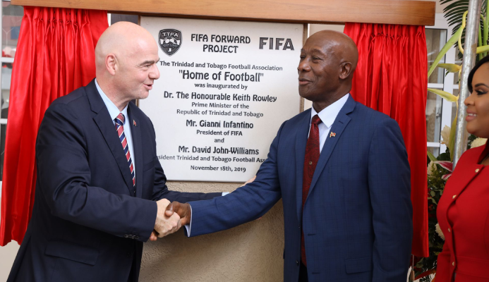 Prime Minister Dr Keith Rowley, right, shakes hands with FIFA president Gianni Infantino after unveiling the plaque during the opening ceremony for the Home of Football in Balmain, Couva, yesterday.  RISHI RAFGOONATH