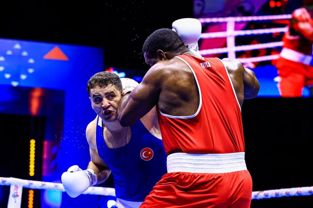 TT heavyweight boxer Nigel Paul (R) and Turkey's Berat Acar fight during the International Boxing Association World Championships 2021 +92kg quater-final match, in Belgrade, Serbia, on Tuesday. - Photo courtesy AIBA
