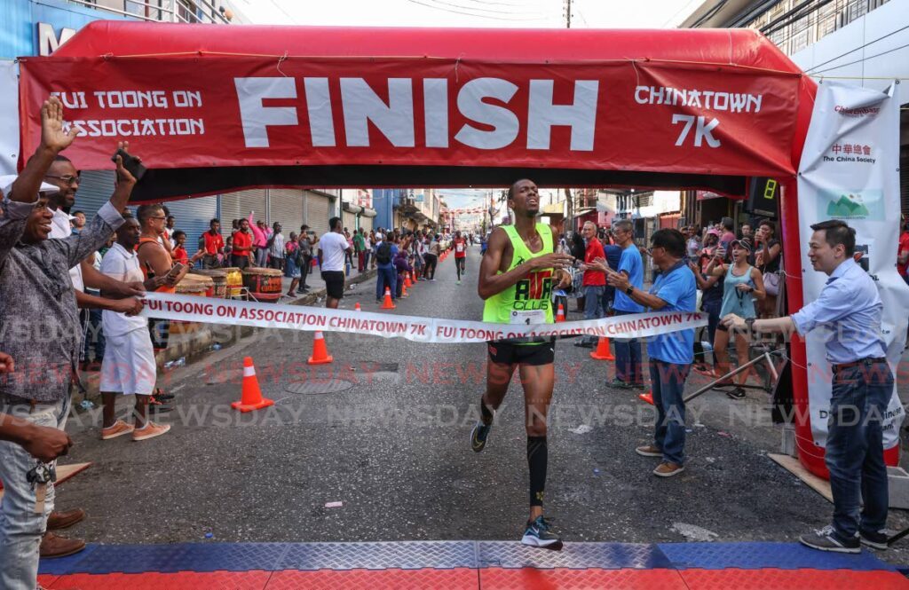Nicholas Romany crosses the finish line to win the Chinatown 7K on Charlotte Street, Port of Spain on Sunday. - Photo by Jeff K Mayers (Image obtained at newsday.co.tt)