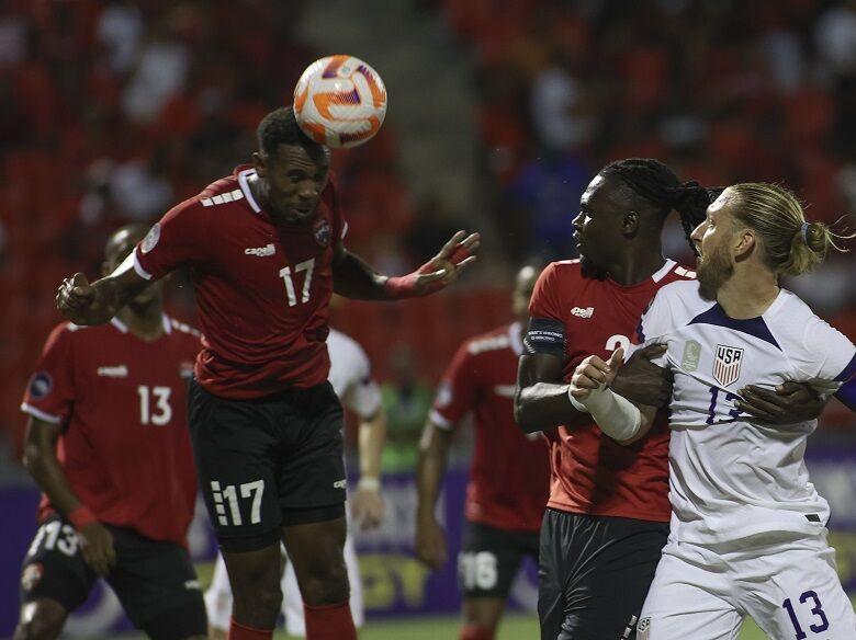 IN CONTROL: Trinidad and Tobago's Justin Garcia, left, makes a clearance, while the United States' Tim Ream, right, looks on during a CONCACAF Nations League quarter-final match at the Hasely Crawford Stadium, Mucurapo, Monday night. -Photo: AP  Azlan Mohammed (Image obtained at trinidadexpress.com)