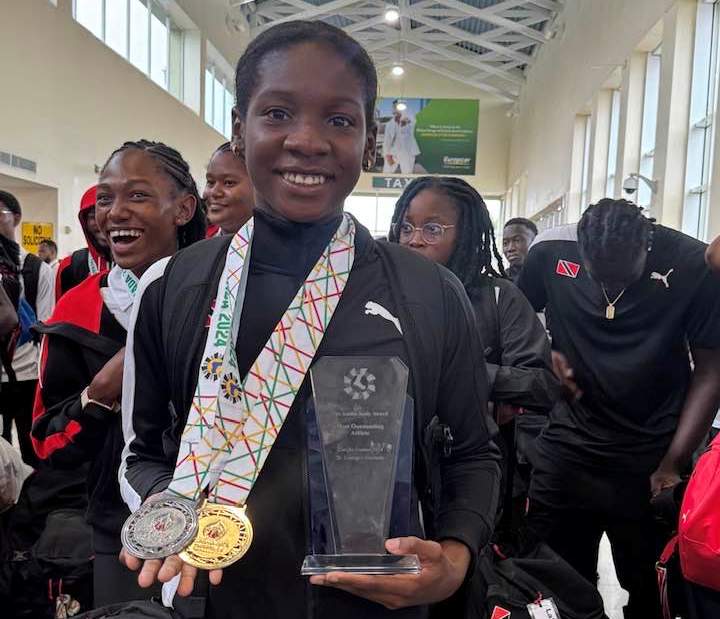 Trinidad and Tobago's Janae De Gannes is all smiles upon returning home on Tuesday from the 2024 CARIFTA Games. (Photo credit - NAAATT) (Image obtained at tt.loopnews.com)